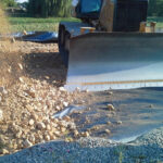 Using small machinery to add stone over H2Ri Tencate geotextile.