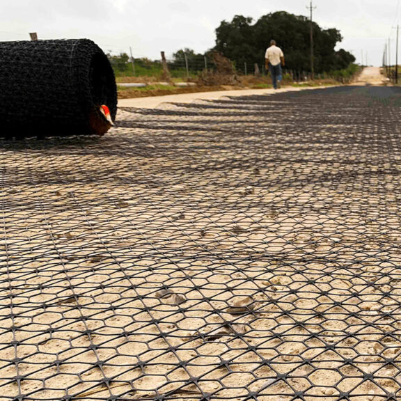 A large roll of professional geosynthetic on a job site