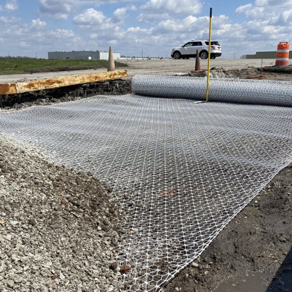 Professional installation of Tensar InterAx Geogrid for road stabilization