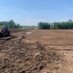 Applying topsoil of geogrids to promote vegetation.