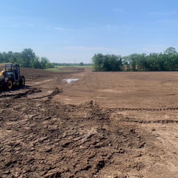 Applying topsoil of geogrids to promote vegetation.