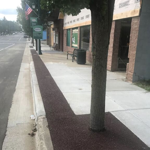 Porous solution for tree surrounds and municipal sidewalks