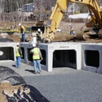 Installing RetainIT chambers on top of geosynthetic fabric and stone for long-term subsurface water management