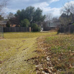 A green vegetated drainage channel ready to handle high flow capacities.