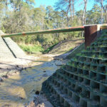 The flexible installation of GEOWEB Vegetated Retaining Wall is ideal for projects with obstructions such as near this sanitary pipe.