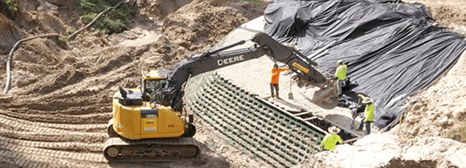 Installing a vegetated MSE retaining wall using GEOWEB to stabilize a slope.