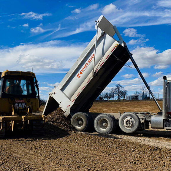 Adding fill aggregate on top of Tencate Mirafi H2Ri geotextile for superior separation, filtration, and more.